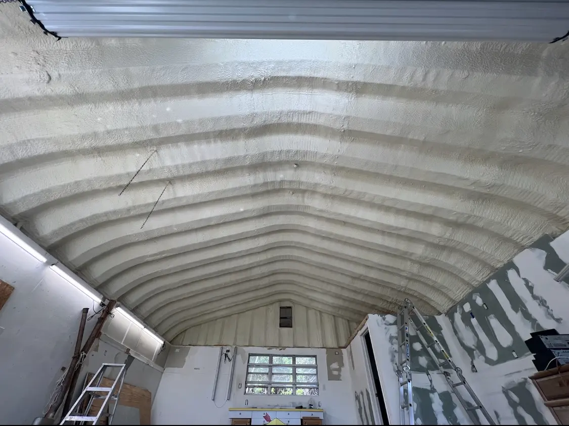 Spray polyurethane foam applied to the underside of a metal roof deck in East Greenbush